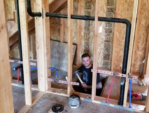 All County Plumbing technician preparing pipe fittings on site