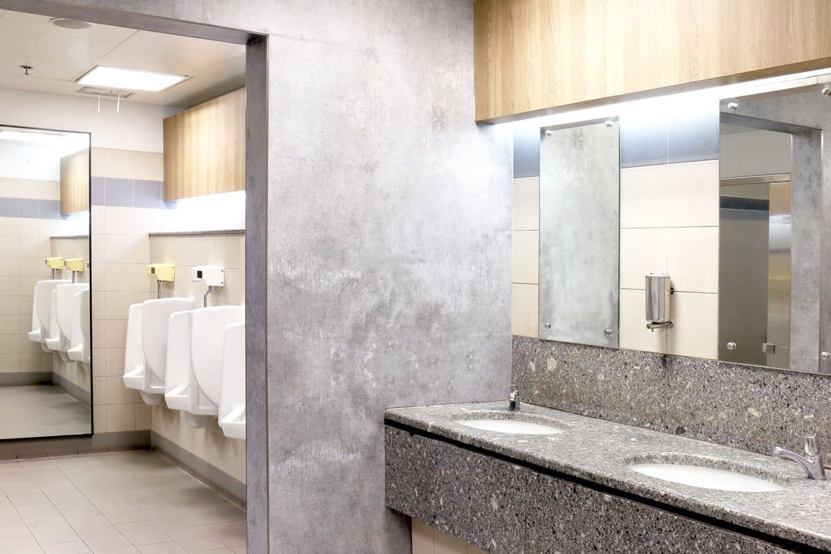 Finished commercial restroom with urinals, sinks and partitions