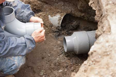 Crew completing sewer hookup installation